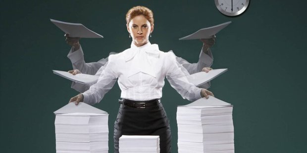 Businesswoman holding sheets of paper, portrait