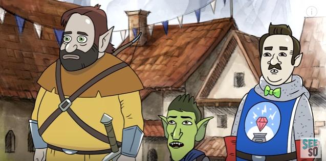 A group of three cartoon characters stands in a medieval village. On the left, a large bearded figure holds a sword, in the middle, a green-skinned character with pointy ears, and on the right, a mustached figure in a futuristic outfit.