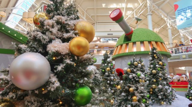 Christmas trees with snow and ornaments with Santa HQ Ovservatory in the background