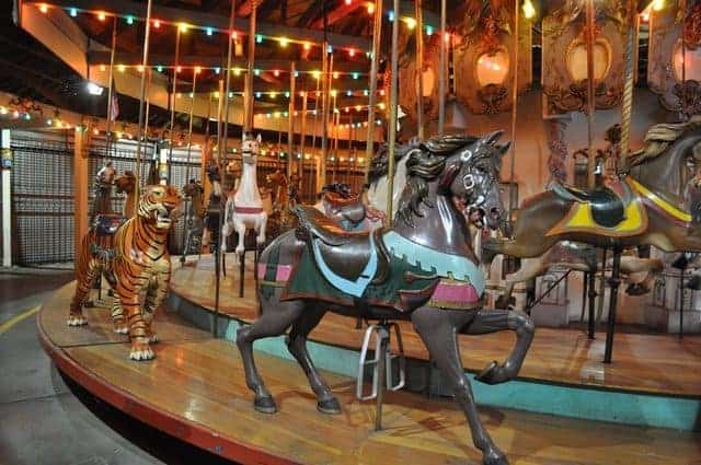The forest park carousel has horses and menagerie animals like the tiger