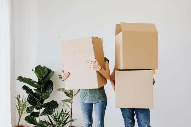 A couple carrying boxes