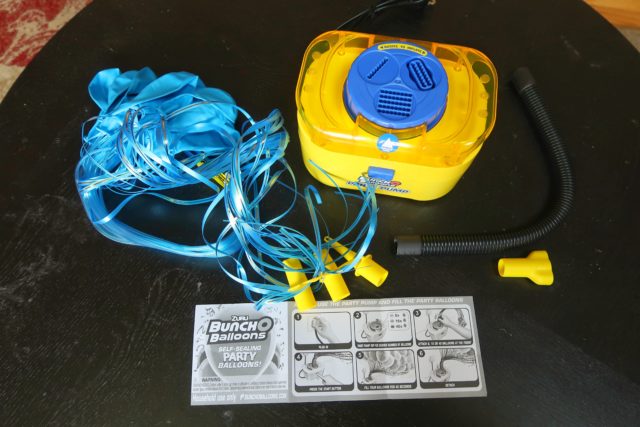 Everything that is included in the Bunch O Balloons starter pack: balloons, pump, hose, and attachments.