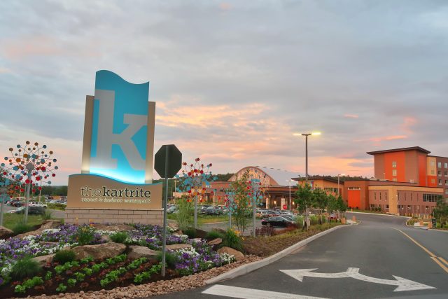 A colorful sky at sunset is the backdrop for this view of the Kartrite Resort's entrance.