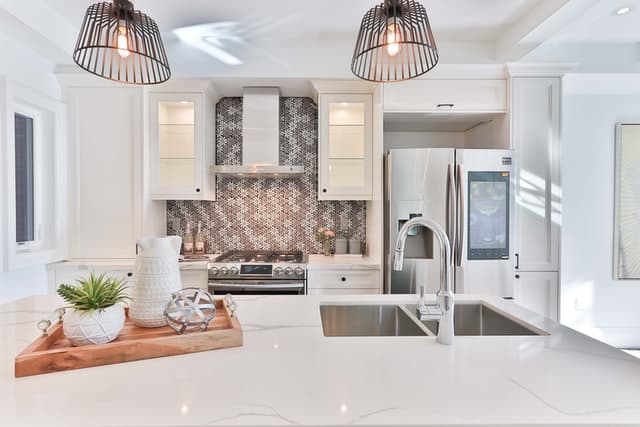 A clean and spacious white and black kitchen