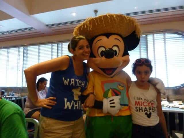 Lisa and Bella hanging with Mickey in his summertime outfit and straw hat at Minnie's Seasonal Dine