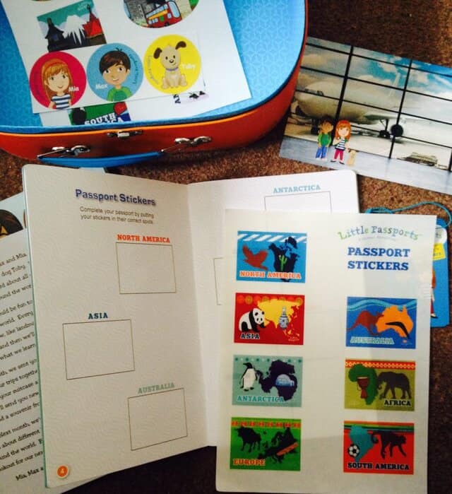 Contents of Little Passports suitcase. Passport with passport stickers