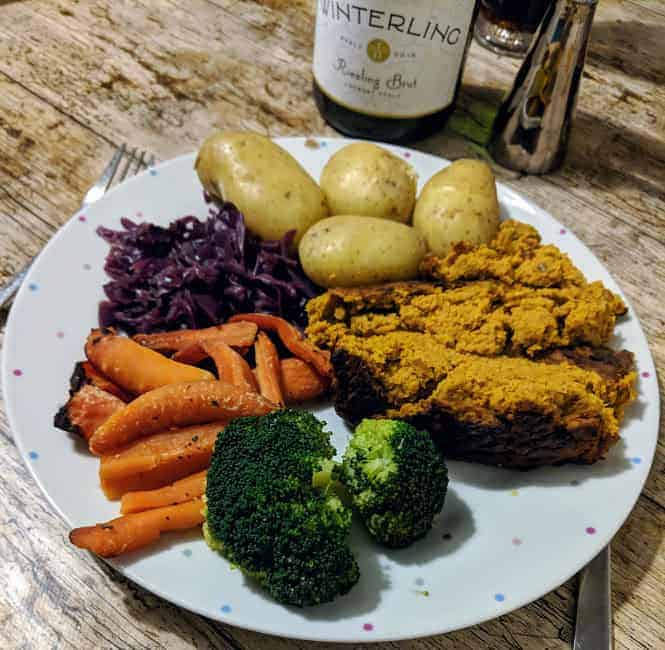 Christmas vegetables on white plate on wooden surface
