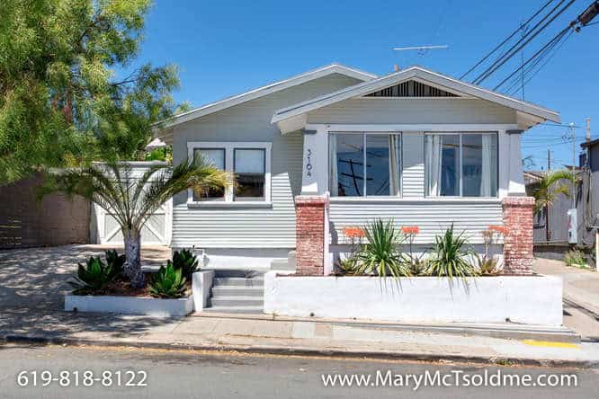Light grey Craftsman bungalow at 3164 Thorn St in North Park with brick pillars, a raised white planter, and drought-tolerant succulents.