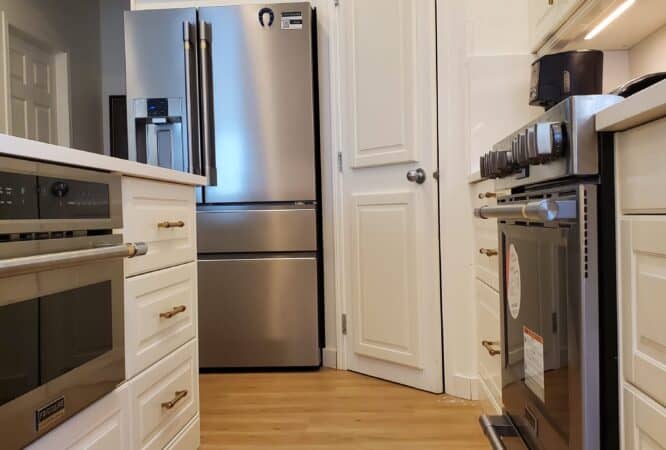 Modern Calgary kitchen renovation with [white shaker cabinets, quartz island, black hardware]