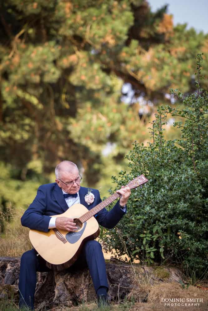 Father of the Groom playing guitar at Coulsdon Manor