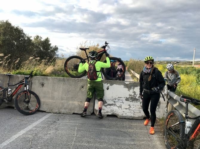 Lifting Bikes Over a Blockade in Sicily. Lifting bikes over a blockade in Sicily.