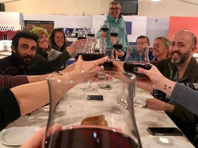 Restaurant in Agritourismo Giannavi in Sicily Group making a toast with red wine at the restaurant in Agritourismo Giannavi in Sicily