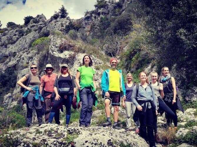 Southeastern Sicily Hike and Bike Tour Small tour group standing on rocks in Pantalica, Anapo Valley in Sicily.