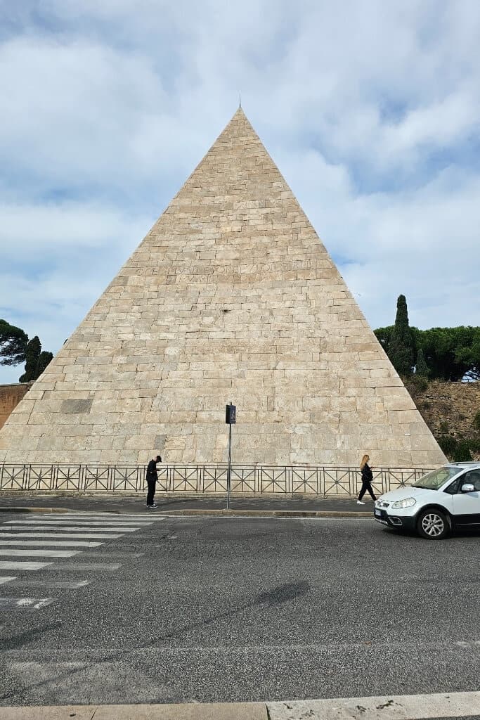 View of the Pyramid of Cestius, an ancient Roman monument located outside Piramide metro station, near Porta San Paolo — departure point for visiting Ostia Antica.