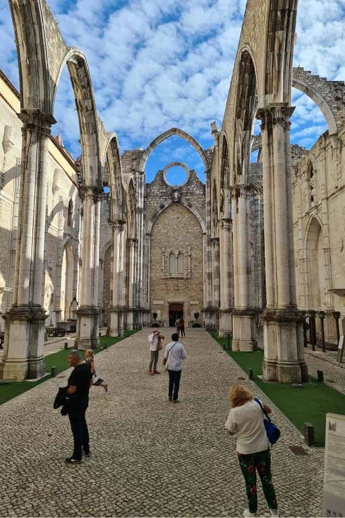 The stunning ruins of the Carmo Convent in Lisbon, featuring gothic arches and an open sky. One of the most unique Lisbon photography spots for history and architecture lovers.