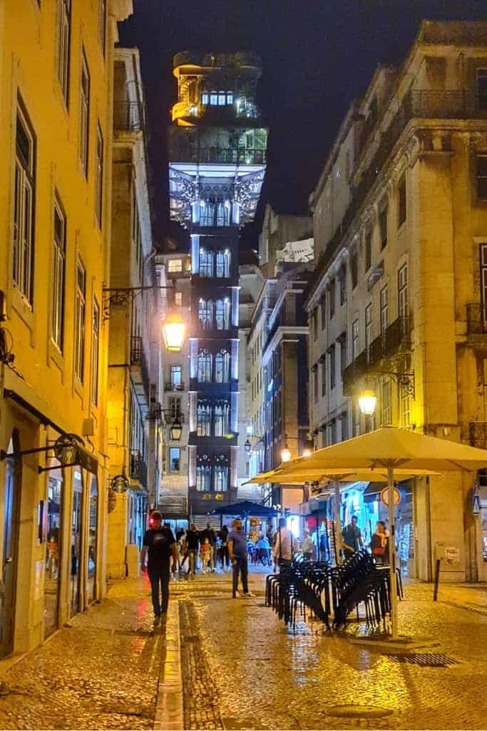 The iconic Santa Justa Lift in Lisbon’s Baixa district, beautifully illuminated at night, offering stunning city views.