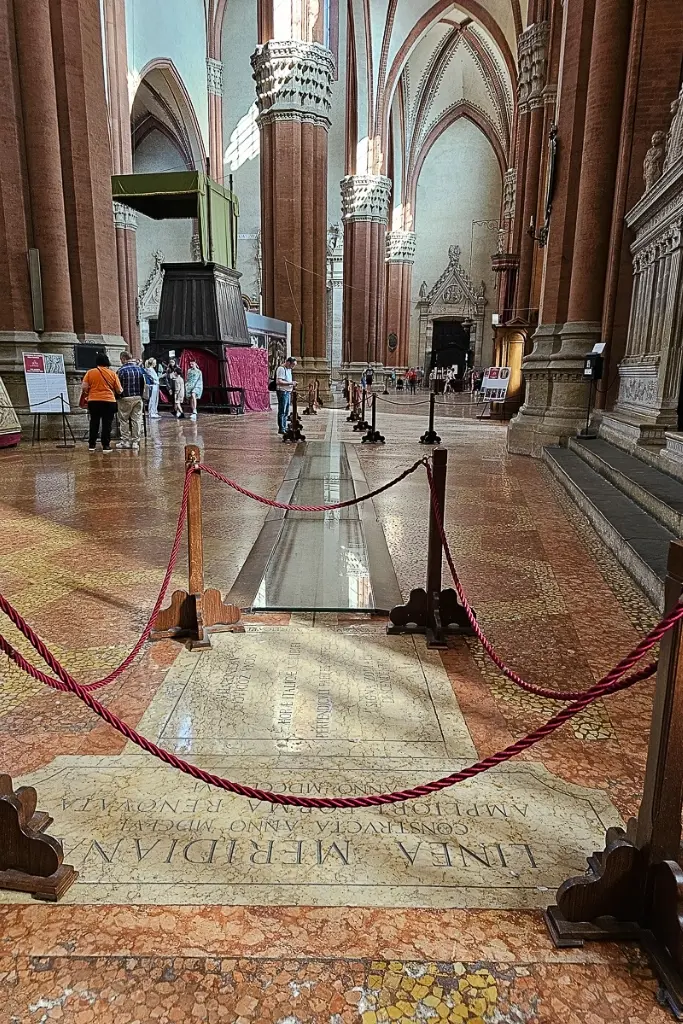 Interior of Basilica di San Petronio in Bologna showcasing the world’s longest indoor sundial running across the floor, a unique scientific and architectural marvel worth photographing.