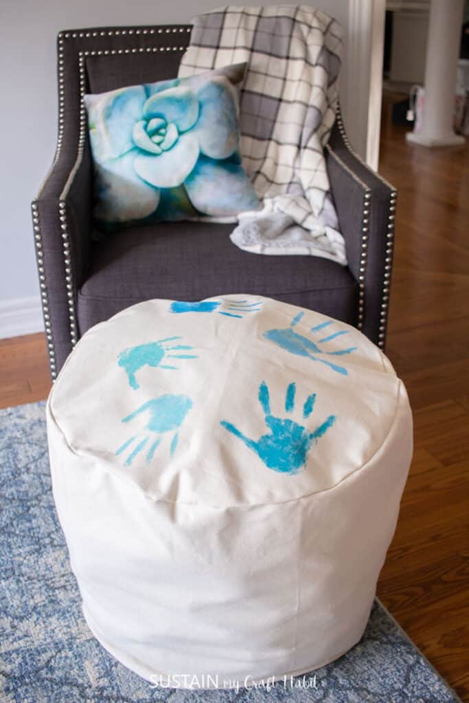 Canvas ottoman in front of a living room chair