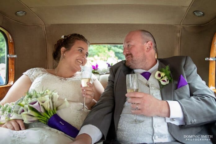 Bride and Groom in their Wedding Car