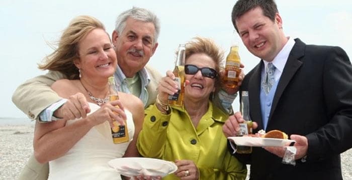 Wedding party cheering with beer and food. Wedding dinner cruise Charleston SC
