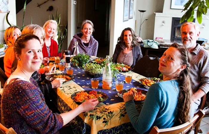My guests eating a healthy vegan dinner on retreat in Canada - with Anastasia Eden