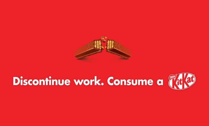 On a red background, a Kit Kat finger breaking and the words 'Discontinue work. Consume a Kit Kat'