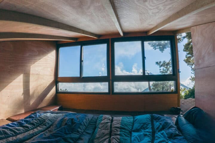 View from inside an OX Expeditions cabin looking toward Fuego volcano through large windows
