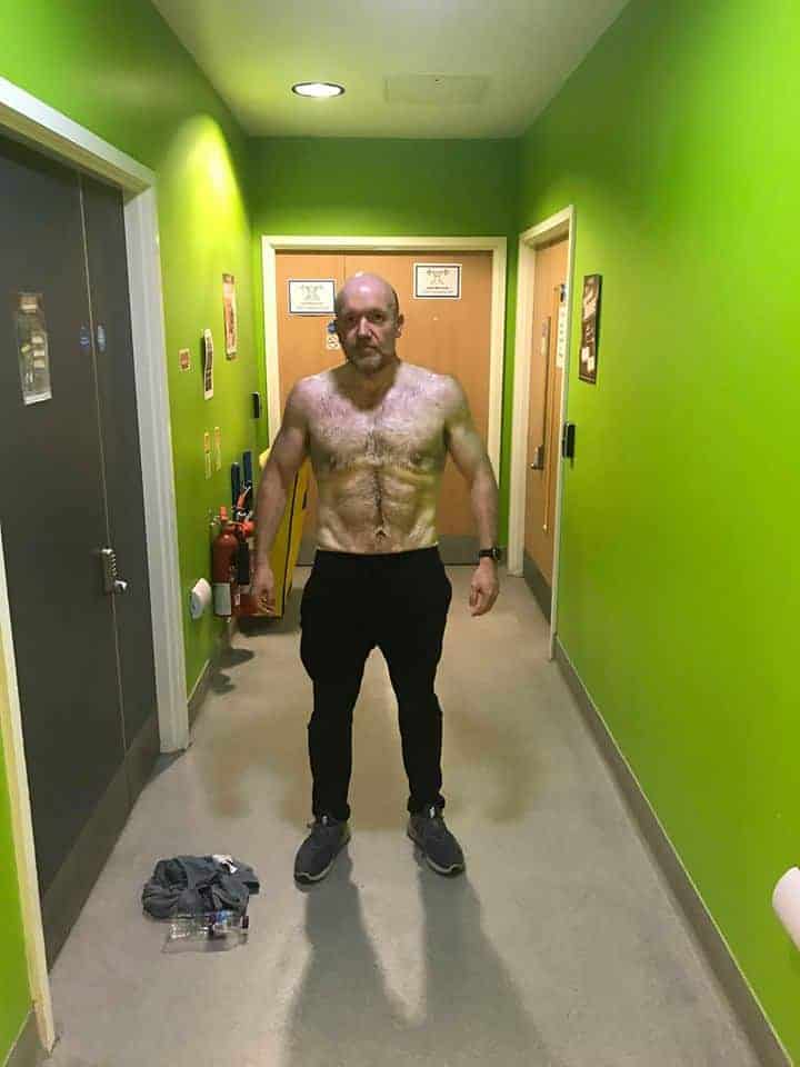 A picture of Adam with no top on and after his weight loss