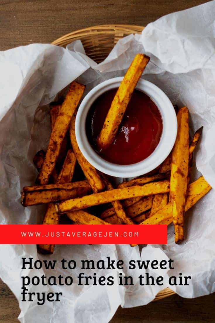 A pinterest friendly image of sweet potato fries in a paper bowl with a dip of ketchup.