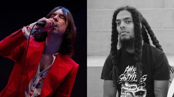 A singer passionately performing on stage with a microphone, dressed in a red blazer, immersed in music performance.