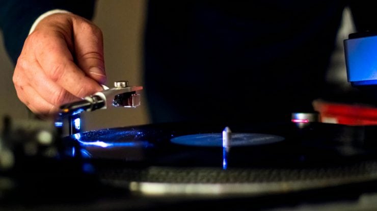 man playing record on a turntable