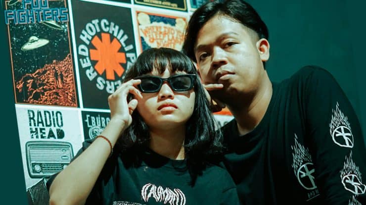 two friends wearing band merchandise