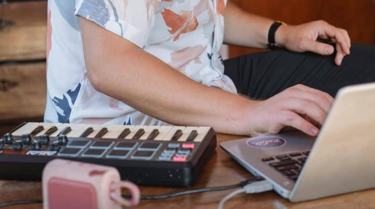 man producing music in at-home studio environment