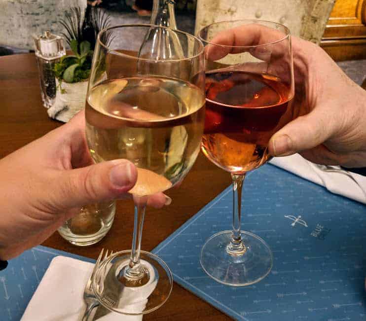 two wine glasses clinking