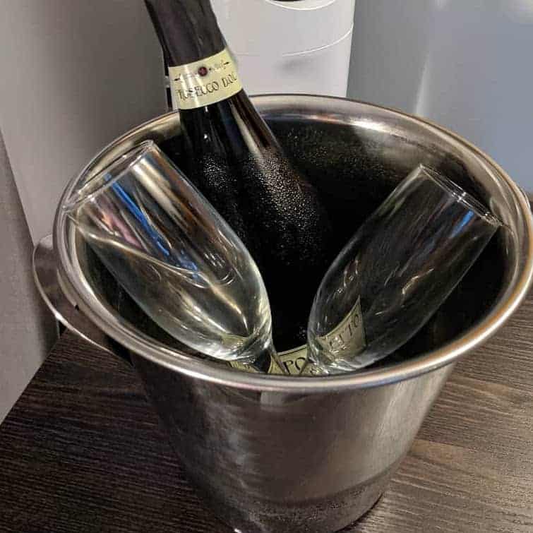 Bottle of champagne and two glasses in silver champagne bucket