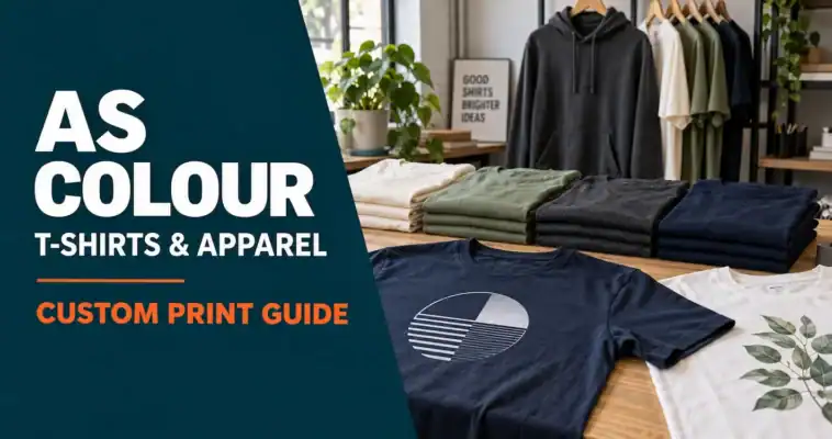 Printed navy and white T-shirts beside folded garments and a hanging hoodie, with an AS Colour custom print guide headline.