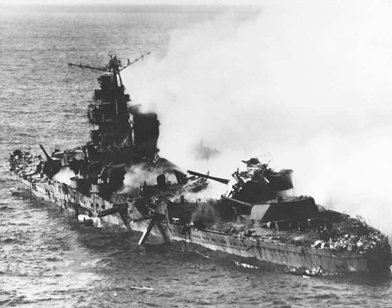 Japanese cruiser Mikuma, June 6, 1942, heavily damaged by bombs from USS Enterprise and Hornet, with shattered midsection and wreckage.