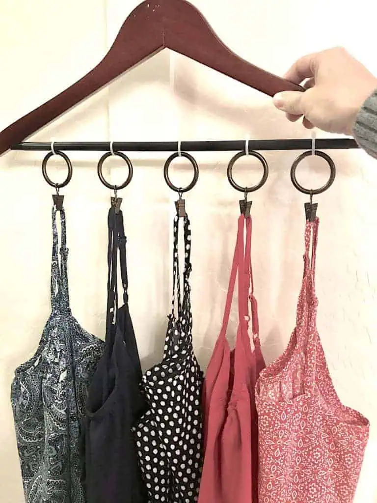 Organize clothes without a dresser: hang multiple tank tops on a single hanger.