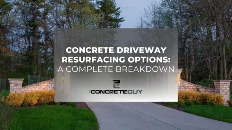 ALT tag: "Concrete driveway resurfacing options overview by The Concrete Guy with stone pillars and lush landscaping backdrop."