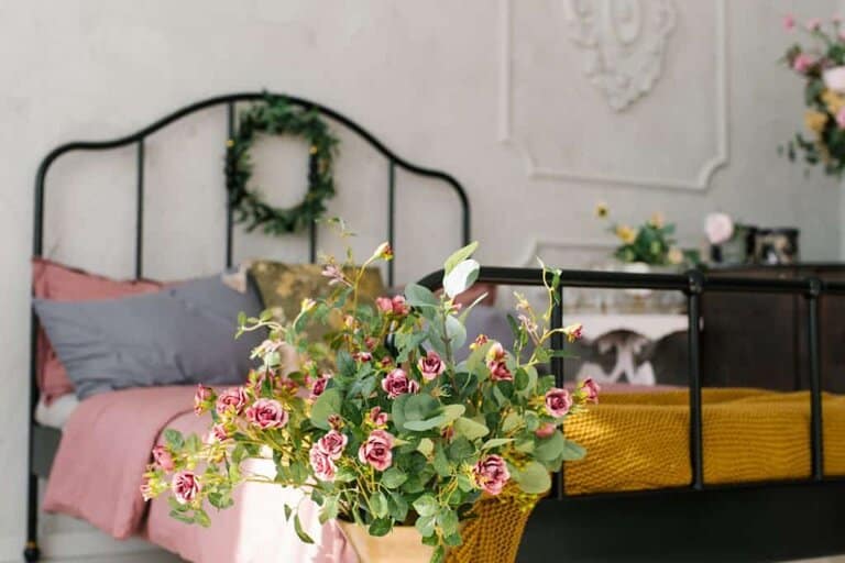 Photo of a Victorian vintage bed with a golden vase