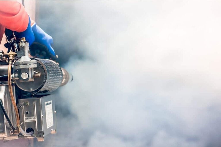 man using machine to fumigate house