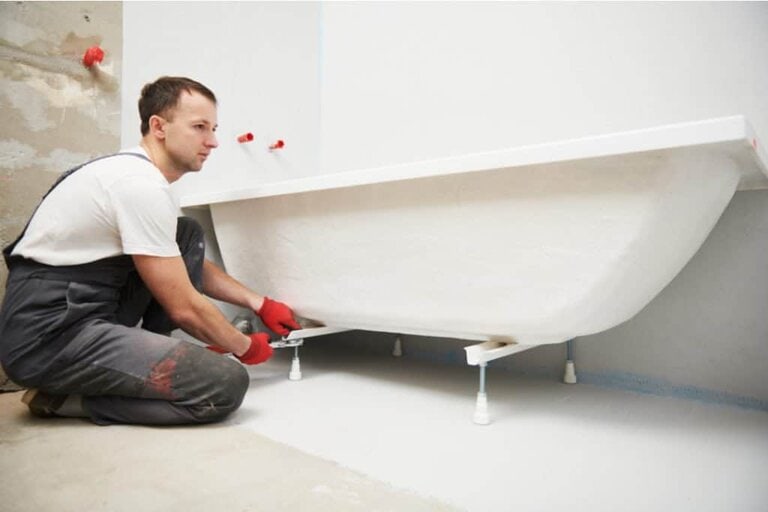 plumber installing bathtub