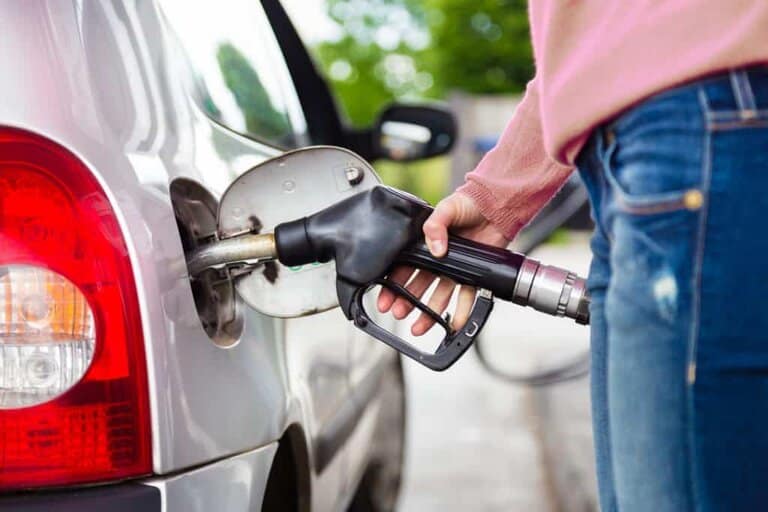 photo of gasoline being pumped into a motor vehicle car.