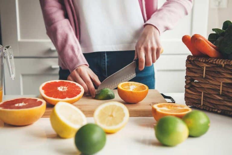 woman cutting citrus fruits