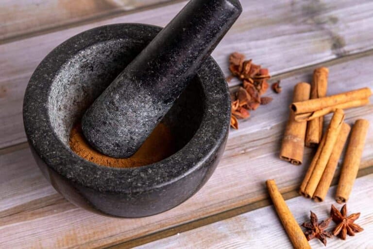 grinding cinnamon with a mortar and pestel