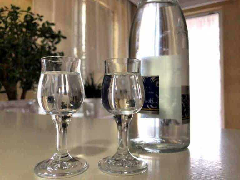 Two glasses of water next to a bottle of water, representing a Polish beverage.