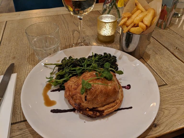 cooked leak and mushroom wellington with purple sprouting brcolli and carrot puree