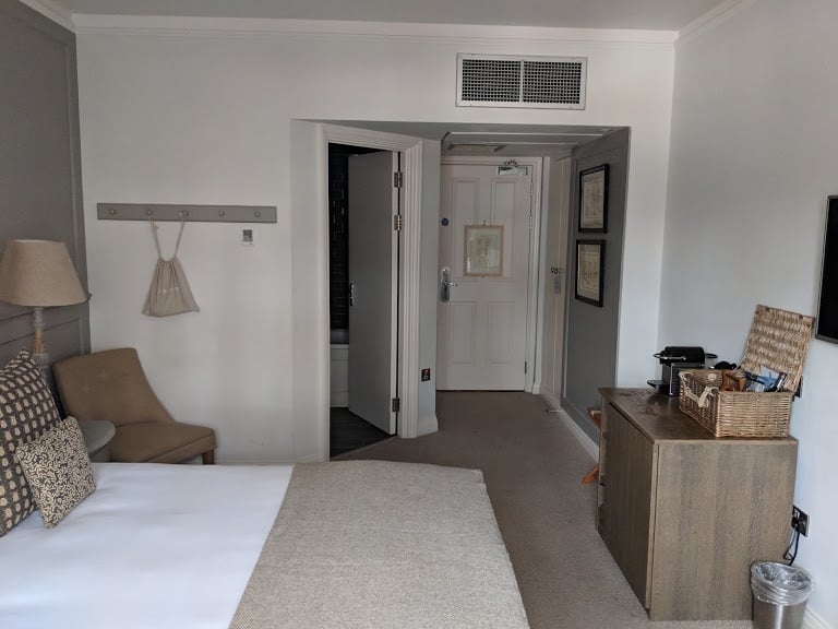 A view of the homely looking room with the bathroom and double bed