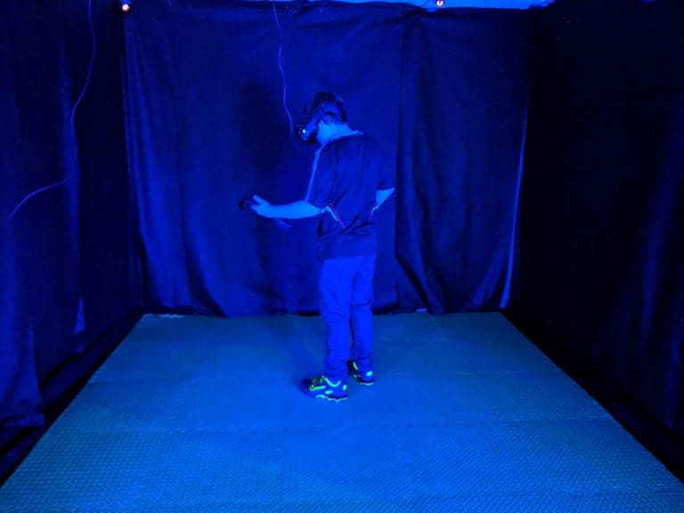 Ben using the Vr headset and hand set whilst he takes a VR journey