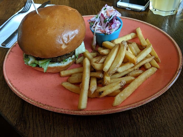 a Buenos Aires burger with french fries and coleslaw on the side
